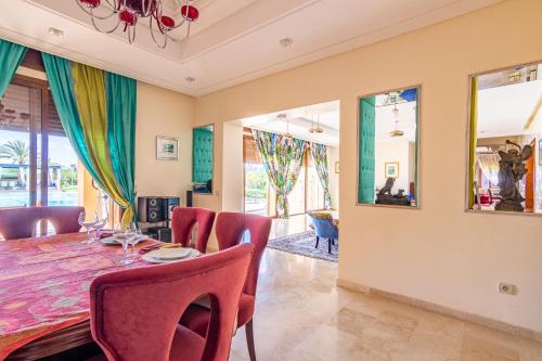 a dining room with a table and chairs at Palais les sources de l'atlas & spa in Marrakesh