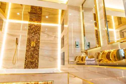 a bathroom with a large mirror and a sink at Alexandras Palace in Bradford