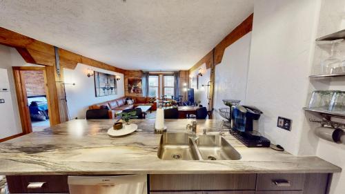 a kitchen with a sink and a living room at The Salt Flat - Salt Lake City in Salt Lake City