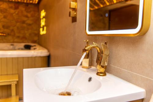 a bathroom sink with water running from a faucet at Alexandras Palace in Bradford