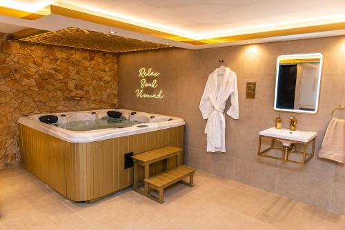 a large bathroom with a tub and a sink at Alexandras Palace in Bradford