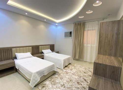 a bedroom with two beds and a couch at Comfort Stay in Taif