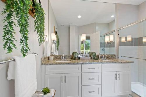 a bathroom with two sinks and a large mirror at Placid Retreat Near Disney Orlando, FL in Orlando