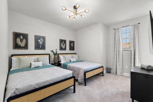a bedroom with two beds and a window at Placid Retreat Near Disney Orlando, FL in Orlando