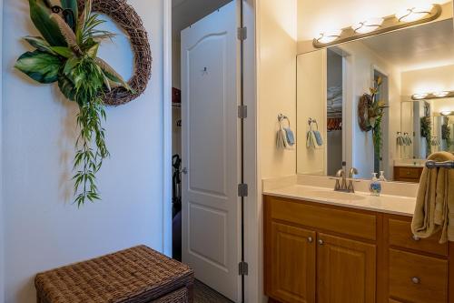 a bathroom with a sink and a mirror at 3bd 3ba Oceanview Condo w Office and AC and WIFI and Garage ACAA1 in Kailua-Kona