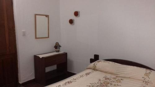 Schlafzimmer mit einem Bett und einem Tisch mit einem Spiegel in der Unterkunft Habitación con Baño Privado en Casa del Zorzal en Tandil in Tandil