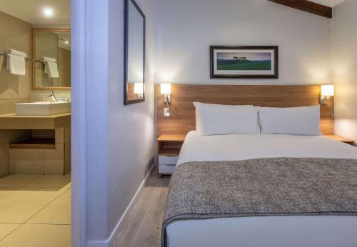 una camera con letto e un bagno con lavandino di Pine Lake Resort a White River