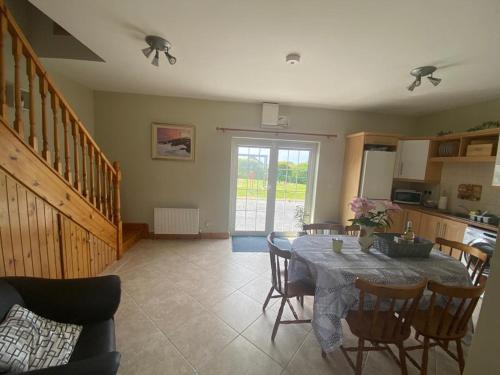 a kitchen and dining room with a table and chairs at Loch Nuala in Galway