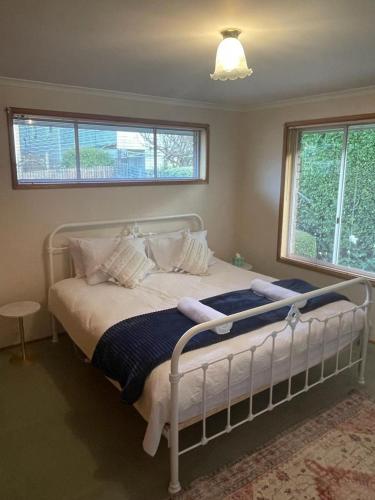 a bedroom with a white bed with pillows and a window at Sandy Bay Villa in Sandy Bay