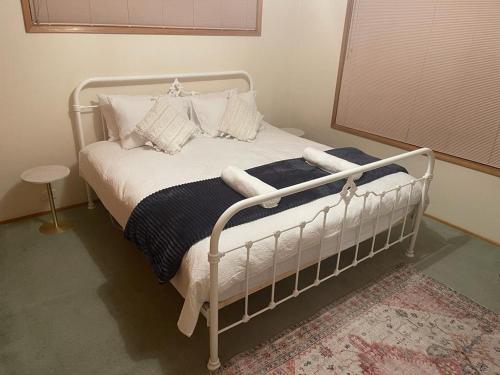 a bedroom with a white bed with pillows at Sandy Bay Villa in Sandy Bay