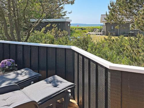 a wooden deck with a bench and a table on it at 7 person holiday home in Løgstør-By Traum in Løgsted
