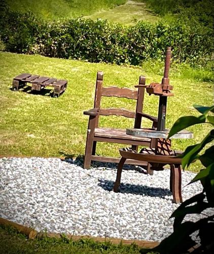 a wooden bench sitting on top of a pile of rocks at Le Macine in Magnano