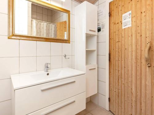 a bathroom with a sink and a mirror at Holiday home Væggerløse CCXVI in Bøtø By