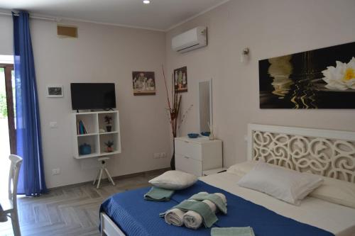 a bedroom with a bed and a tv in it at Casacecilia relax in Siracusa