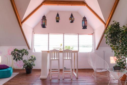 a room with a table and chairs in a attic at Casa Ramona in Flores