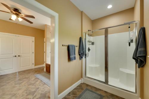 a bathroom with a shower and a ceiling fan at 4 Mi to Branson Landing Huge Home with Game Room! in Branson