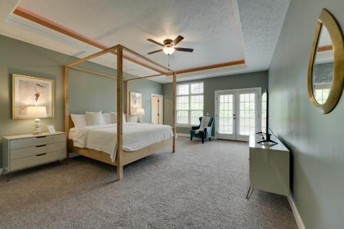 a bedroom with a canopy bed and a ceiling fan at 4 Mi to Branson Landing Huge Home with Game Room! in Branson