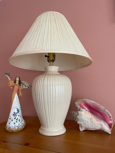 a white lamp sitting on top of a table with a doll at Panoramic Ocean View in Nanaimo