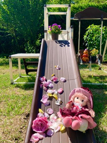 a doll on a slide with pink hearts and butterflies at 富士の樱House 宝栄 in Fujikawaguchiko