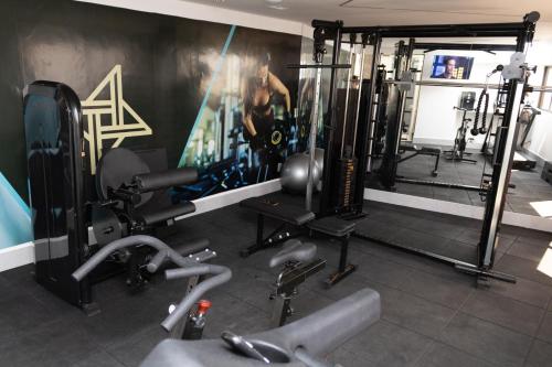 a gym with a video game on the wall at Arpoar Suítes 330 in João Pessoa