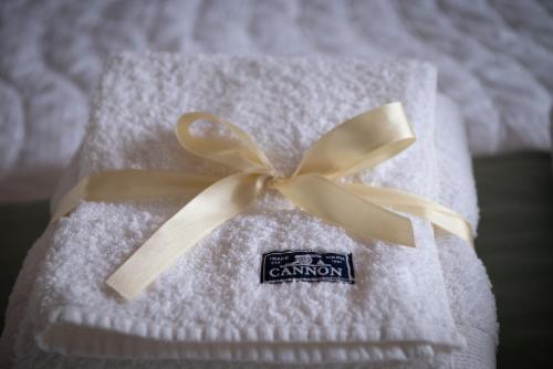 Maipu Luxury Apartment في مايبو: منشفة بيضاء عليها قوس اسمر