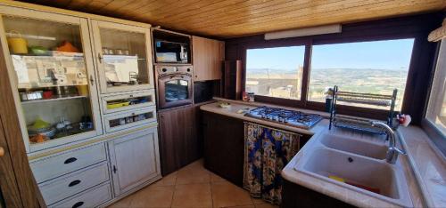 a kitchen with a sink and a window at Al corso 3 in Naro