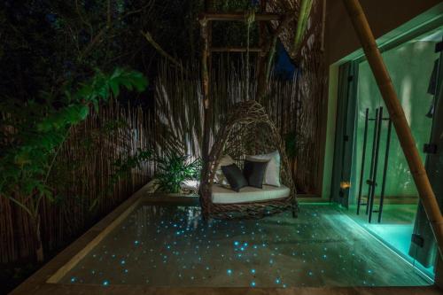 a porch with a hammock and a pool at Hotel Villas Flamingos in Holbox Island