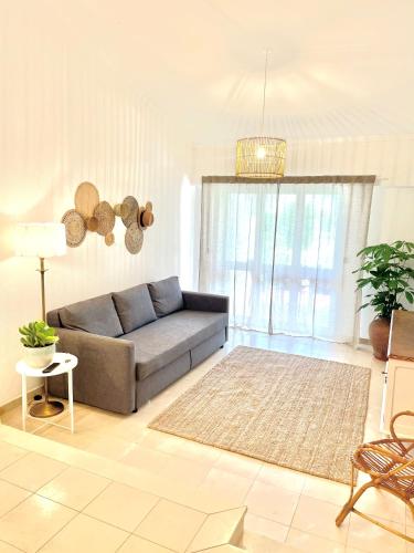 a living room with a couch and a rug at Detailed Villa - In Vilamoura's Heart in Vilamoura