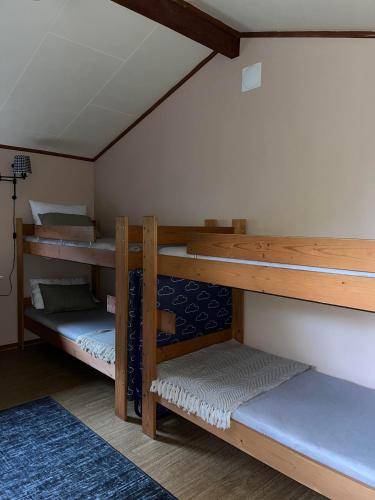 a room with three bunk beds in a room at Basecamp Birtavarre in Birtavarre