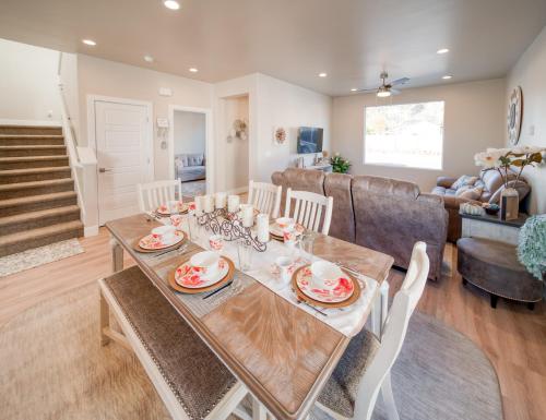 a dining room and living room with a table and chairs at South Zion Coral Cliffs - 4 bed, 3 bath, hot tub, deck in Hildale