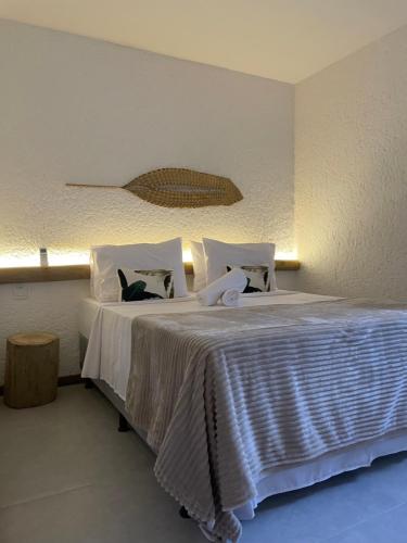 1 dormitorio con 1 cama con sábanas y almohadas blancas en Villa Kamby Milagres B004 en São Miguel dos Milagres