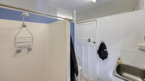 a bathroom with a sink and a towel rack on the wall at Desert Hideaway - White Cliffs in White Cliffs
