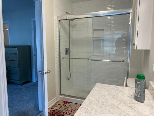 a shower with a glass door in a bathroom at Stay with Star in Ottawa