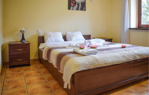 a bedroom with a bed with flowers on it at Beautiful Apartment In Rydzewo With Kitchen in Rydzewo