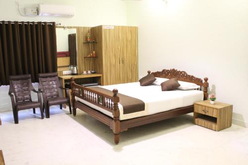 Säng eller sängar i ett rum på Indian Residency