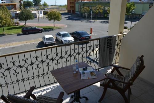a table and chairs on a balcony with a view of a street at Lotus Family Hotel - Free Parking in Sunny Beach