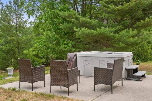 a group of chairs and a white table with a table and chairsktop at LONG LAKE RETREAT- Hot tub, Pool table, Firepit in Traverse City