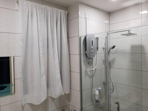 a bathroom with a shower and a shower curtain at Alpine Conezion Golf View Netflix at IOI City Mall in Putrajaya