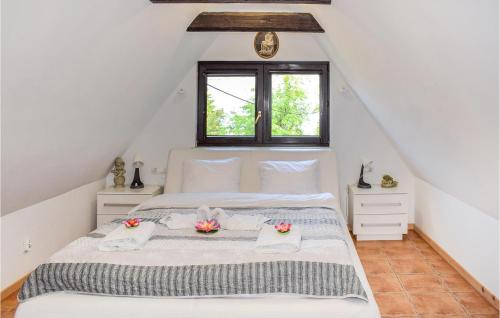 a bedroom with a white bed in a attic at 1 Bedroom Amazing Apartment In Rydzewo in Rydzewo