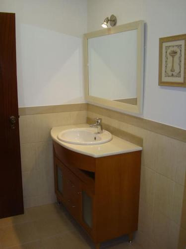 a bathroom with a sink and a mirror at 1Bed Tagus River View in Alhandra