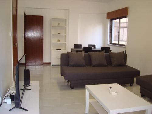 a living room with a couch and a table at 1Bed Tagus River View in Alhandra