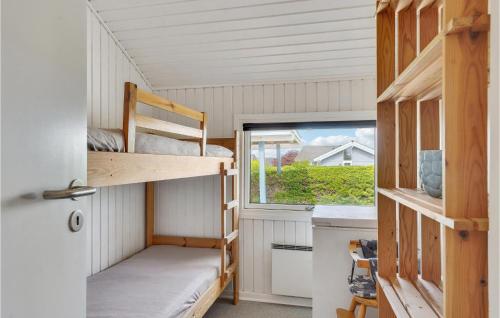a tiny house with two bunk beds and a window at Holiday Home Vesterbakken Assens Ii in Assens