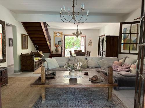 a living room with a couch and a table at Villa Bougainvillea piscine et proche lagon in La Saline les Bains
