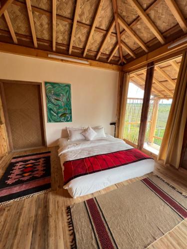 a bedroom with a bed in a room with windows at Moon Nest in Dhoāpālong