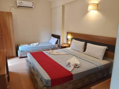 a hotel room with a bed with a towel on it at Sea Breeze Beach Resort Candolim, Goa in Candolim