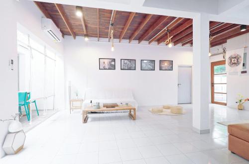 a living room with a couch and a table at Ratchada Retreat Boutique Villa 1 in Bangkok