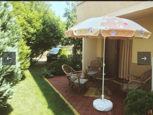 a patio with a table and an umbrella at Lake apartments in Struga