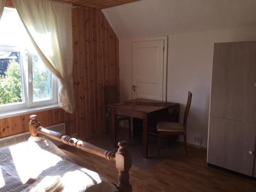 a room with a bed and a table and a window at Angelhouse studio in Tartu