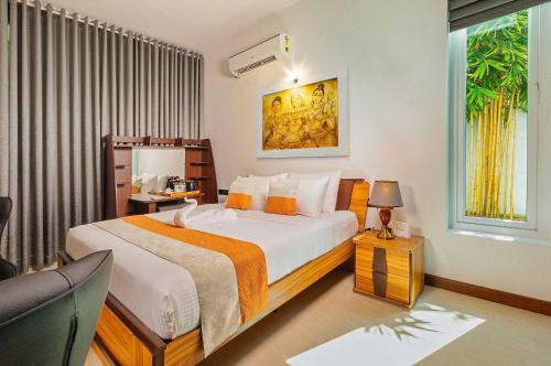 a bedroom with a large bed and a window at The Palace by Ocean in Bentota