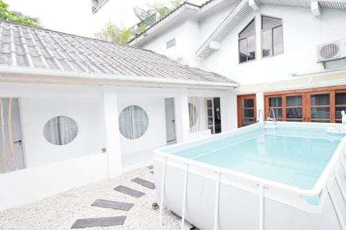 a pool in the backyard of a house at Ratchada Retreat Boutique Villa 1 in Bangkok